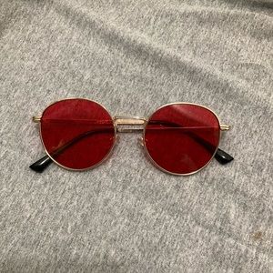 Red sunglasses with gold outline.